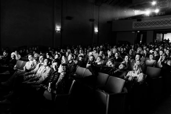 Oameni într-o sală de cinematograf, alb negru